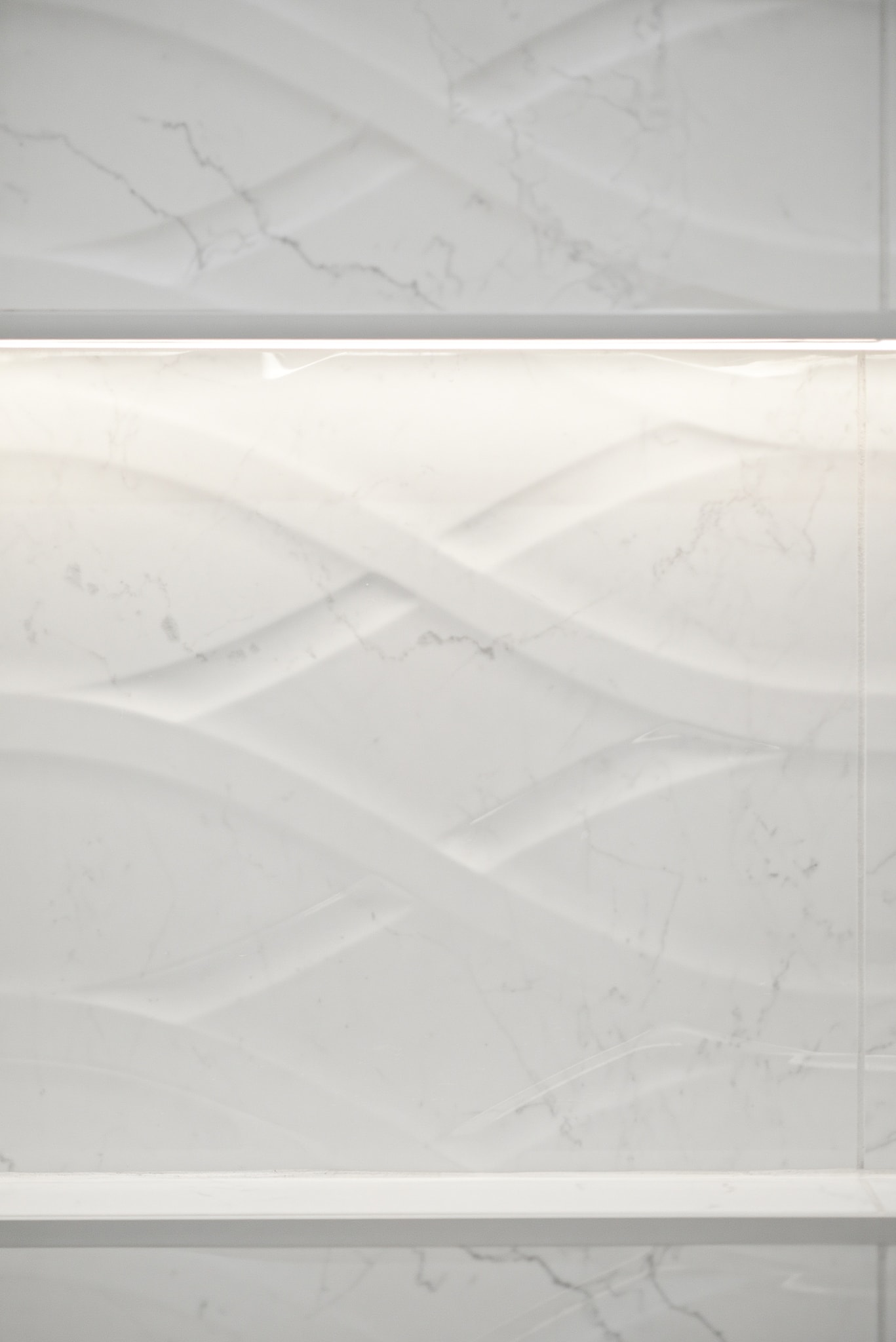 Marble tile shower niche detail with LED lighting