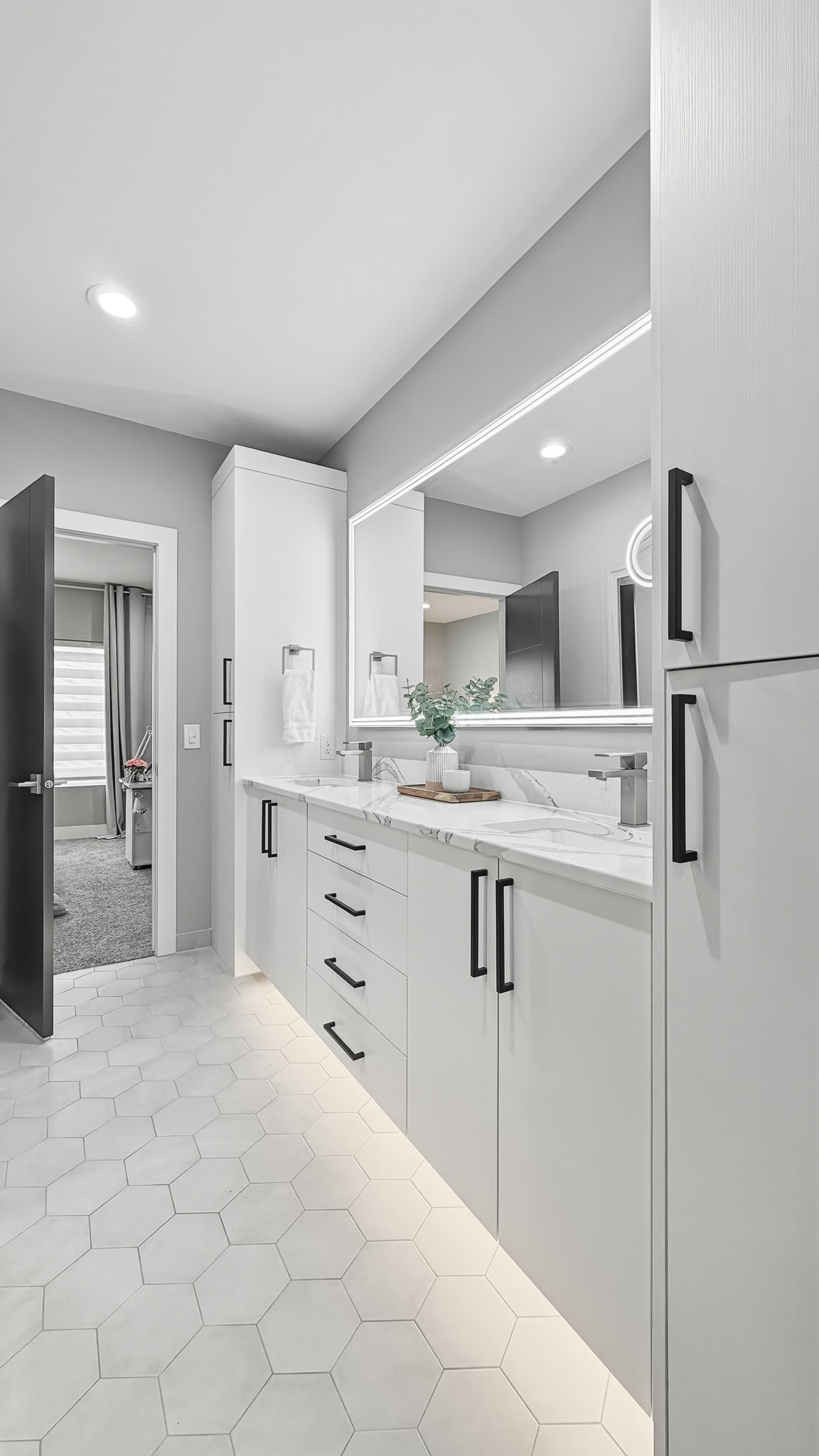 Modern bathroom with white cabinetry and marble countertop