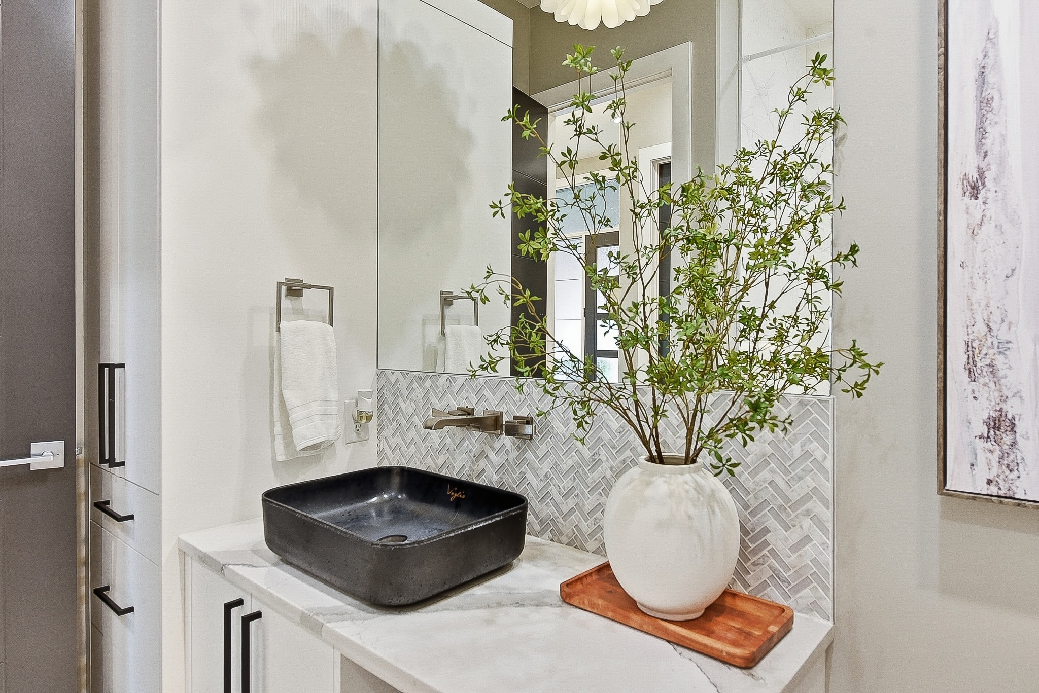 Bathroom vanity with herringbone backsplash and vessel sink